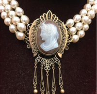 Turn of century stone cameo carving on a three strand pearl necklace. Nobel Antique jewelry Store, Santa Monica. Made in America.Circa 1880s.
